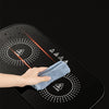 Cleaning the surface of a Portable Electric Food Warming Tray with a cloth to maintain hygiene and shine.