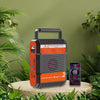 4500mAh Solar Lighting System with Bluetooth Speaker in a garden setting next to a smartphone.
