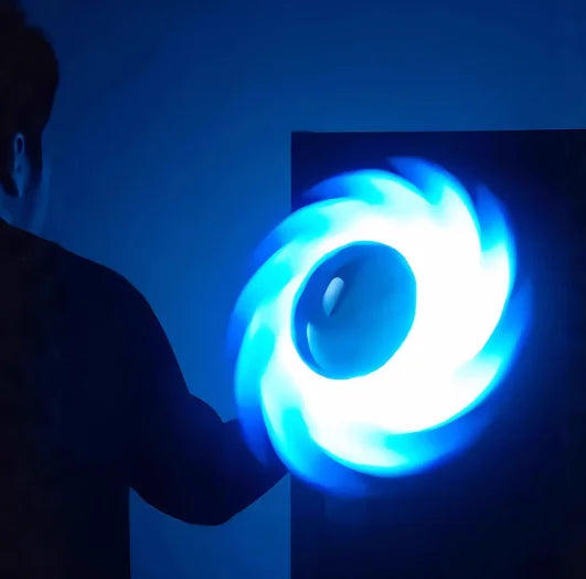 Person playing with a 3D Printed Glowing Rotatable Ace Ring Toy, showcasing vibrant spinning lights in a dark setting.