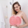Soft Body Massage Bath Brush being held by a smiling woman in a shower, showing its exfoliating texture.