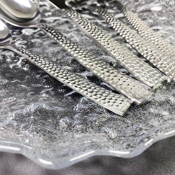 5-Piece Silverware Set displayed on a textured glass plate with detailed silver handles.