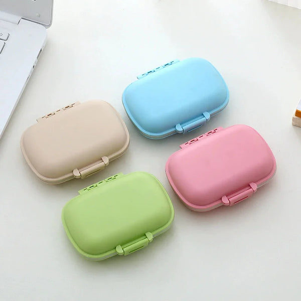 Weekly Pill Organizer Case in four colors: beige, blue, green, and pink, ideal for medication organization.
