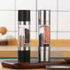 2-in-1 Stainless Steel and Bamboo Manual Grinder showcasing salt and pepper in a modern kitchen setting.