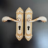 Modern White European Door Handle set with ornate gold and white design for elegant interiors.