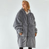 Oversized Sherpa Wearable Hoodie Blanket worn by a model, showcasing the cozy and plush design in gray.