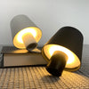 Portable LED touch table lamp on books, showcasing elegant design and adjustable warm lighting.