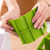Hands holding a green Modern Multifunctional Kitchen Countertop Storage Rack for organizing kitchen essentials.