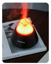USB Mini Volcano Humidifier creating a soothing mist with a vibrant orange light, placed on a magazine.