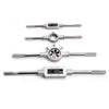 Set of four metal taps and dies, showcasing the tools included in the 110-Piece Tap and Die Set with Case.