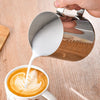 Silver Coffee Latte and Milk Frothing Pitcher 350ML pouring milk into a latte with a leaf design.