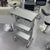 Aluminium Salon Trolley with three storage compartments and wheels, ideal for salon organization and mobility.