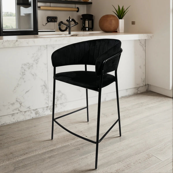 Upholstered Bar Stool with Curved Back and Black Metal Frame in a modern kitchen setting.