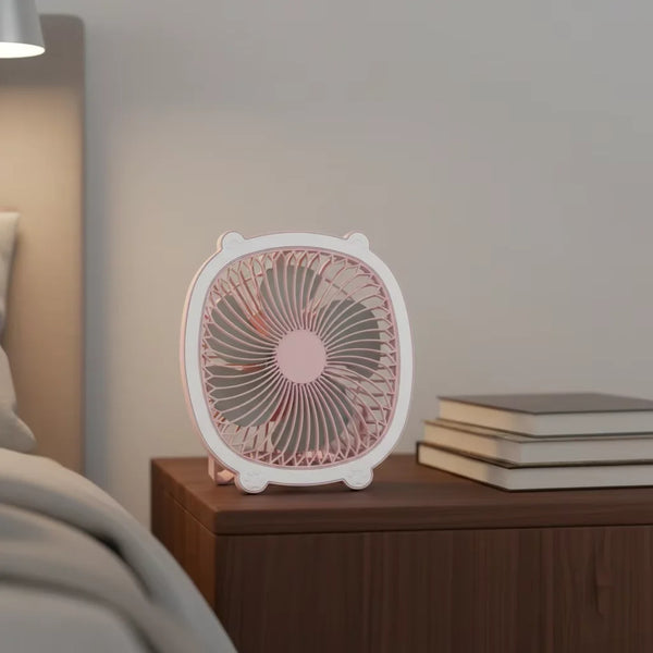 Fresh Color Box Desk USB Fan Rechargeable Cooling Fan on a bedside table next to stacked books.