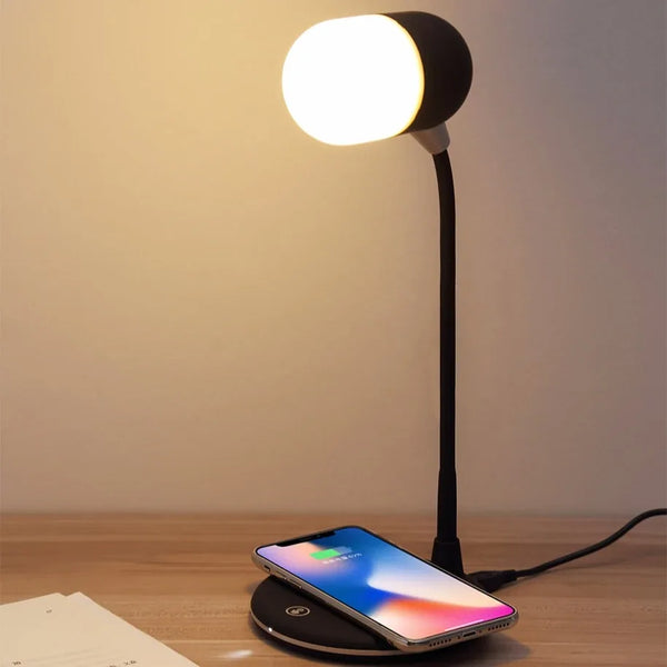 Wireless 15W Charging Bluetooth Speaker with LED Touch Lamp on a desk with a smartphone charging.