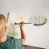 Child painting with a brush using a Paint Palette Resin Mold on the table, showcasing creativity and DIY art.
