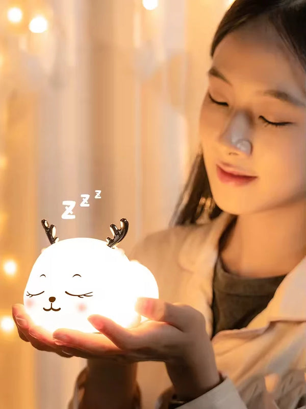Cute Deer RGB Colorful Pat Control Night Light held by a young woman in a cozy setting.