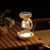 Portable Rechargeable Mosquito Trap Lamp on a wooden table with plants, designed for insect-free outdoor evenings.