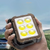 Portable Solar LED COB Work Light in hand, showcasing its bright COB light for outdoor and emergency use.