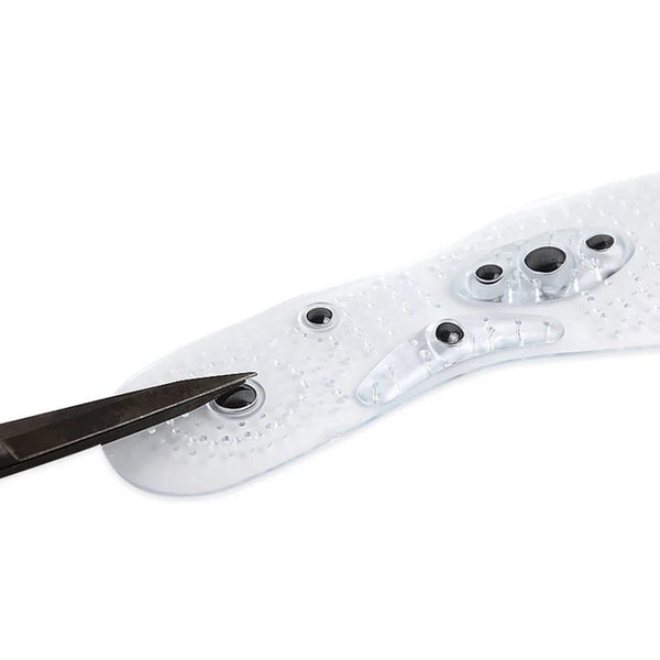 Magnetic Therapy Breathable Massage Insoles being adjusted with scissors for a perfect fit.