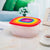 7-Piece Stackable Rainbow Food Storage Container Set with colorful lids stacked in a kitchen setting.