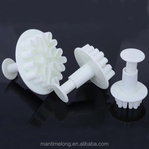 Snowflake Plunger Cookie Cutter Set displayed with three white plunger cookie cutters for easy baking decorations.