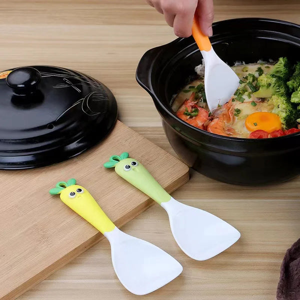 Creative Carrot Plastic Rice Scoop in use with colorful spoons serving vegetable dish.