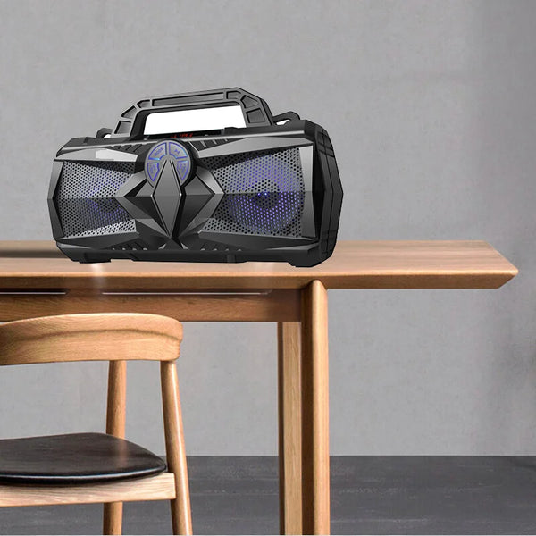 Portable Bluetooth Outdoor Speaker with LED Display on a wooden table.