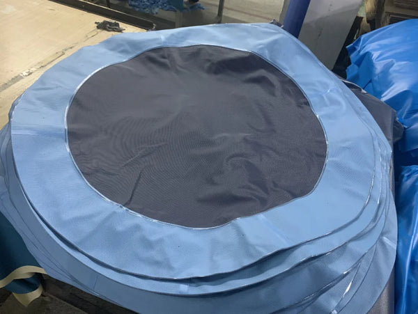 Outdoor Kids Water Spray Play Pool with blue edges and mesh center for water play fun.