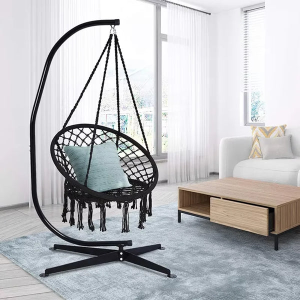 Portable Heavy Duty Outdoor Rope Hammock hanging in a modern living room with a cozy cushion.