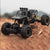 High Quality 4WD Alloy Climbing Off-Road Truck navigating rough terrain with rugged tires and detailed design.