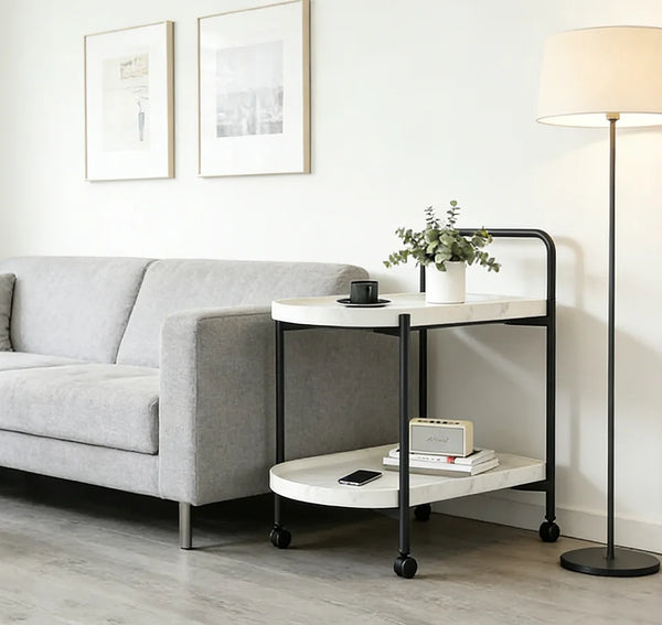2-Tier Marble-Effect Side Table on Wheels with Black Metal Frame beside a sofa in a modern living room.