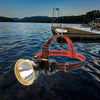 Super Bright LED Headlamp with Safety Warning Light on a scenic lake shore.