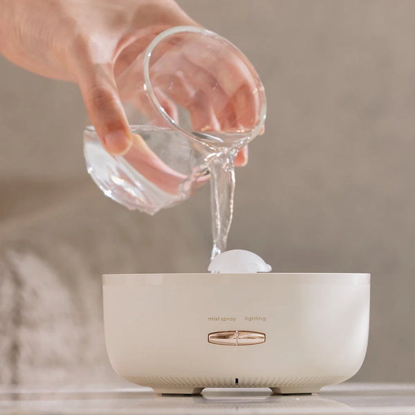 User pouring water into the 400ml Ultrasonic Essential Oil Diffuser with Remote Control.