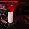 The Mini 420ml USB Air Humidifier on car center console with colorful mist and stylish design.