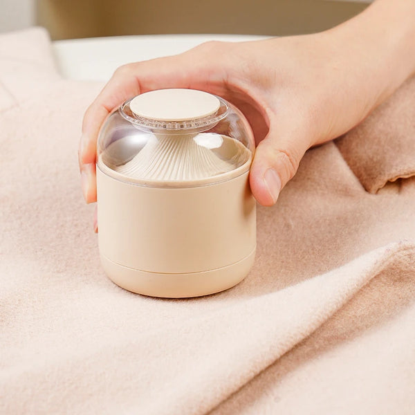 Electric Fabric Lint Remover in use on soft fabric, effectively removing lint and pilling for a refreshed look.