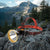 Super Bright LED Headlamp with Safety Warning Light on rocks in a mountainous landscape, ideal for outdoor activities.