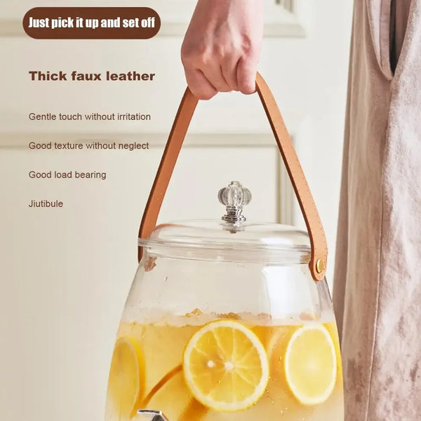 Glass Beverage Dispenser with Faucet featuring thick faux leather handle for easy lifting and pouring of beverages.