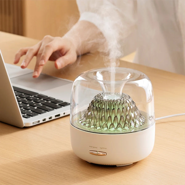 400ml Ultrasonic Essential Oil Diffuser with Remote Control releasing mist next to a laptop on a desk.