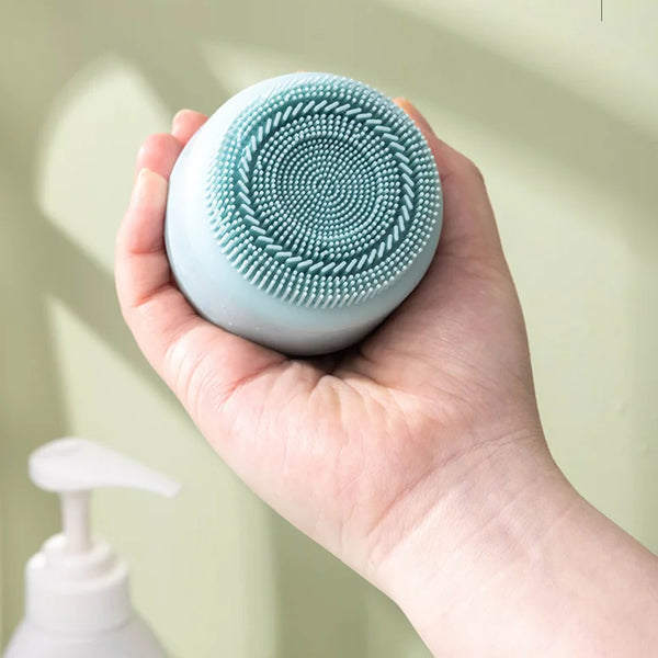 Reusable Silicone Ice Face Roller with Facial Brush in a person's hand, showcasing the textured pad for cleansing.