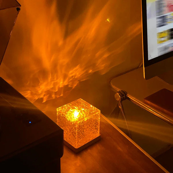 USB Ocean Wave Dynamic Water Ripple Pattern Lamp casting warm orange light effects on a wall in a cozy room setting.