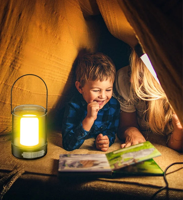 A child and adult reading inside a tent, illuminated by a Portable USB Camping & Tent Lamp.