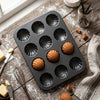Carbon Steel Shell Shape Baking Mold with baked madeleines on a rustic wooden table.