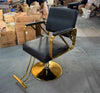 Professional Salon Hydraulic Styling Chair with gold base and black upholstery in a salon setting.