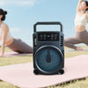Portable Wireless BT Speaker with RGB Night Light placed on a mat during yoga practice outdoors.