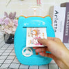 Suitcase Design Piggy Bank ATM Money Safe Box for Money with a hand inserting cash into the colorful ATM-style storage.