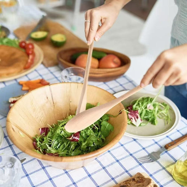 Nature Bamboo Wooden Coffee Milk Stir Spoon mixing salad in a large wooden bowl, eco-friendly kitchen utensil.