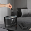 Person adding essential oil to the 2000ml Volcanic Aromatherapy Humidifier on a table.