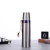 600ml Stainless Steel Thermos Bottle on a table next to a chess set and decorative items.