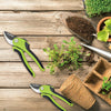 Garden Anti-Slip Handle Bypass Pruner on wooden table with soil, plants, and gardening tools.