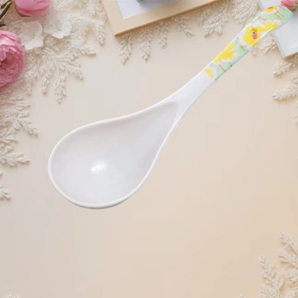 Ceramic Flower Handle Soup Spoon on a decorative surface with roses and elegant design elements.